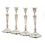 A SET OF FOUR SCOTTISH VICTORIAN SILVER NEO CLASSICAL STYLE SILVER CANDLESTICKS with nozzles, 31cm