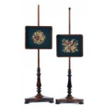 A PAIR OF VICTORIAN ROSEWOOD POLE SCREENS, C1840 with contemporary woolwork banner of a bird on a