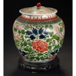 A CHINESE WUCAI JAR AND COVER, 20TH C with peach knop, enamelled with dogs of Fo and floral meander,