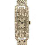 A SWISS DIAMOND SET PLATINUM COCKTAIL WATCH with articulated lugs, on 9ct white gold bracelet,