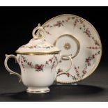 A DERBY TWO HANDLED OGEE CUP, COVER AND SAUCER, C1775 attractively painted in polychrome with