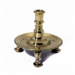 A BRASS THREE FOOTED DESK CANDLESTICK, POSSIBLY DUTCH, EARLY 18TH C 12.5cm h ++One foot slightly