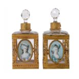 A PAIR OF FRENCH GILTMETAL MOUNTED GLASS SCENT BOTTLES, C1900 each set with a decorative miniature