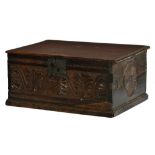 A CHARLES II BOARDED OAK DESK BOX, LATE 17TH C the chip carved front centred by leaves and S