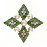 A DIAMOND, DEMANTOID GARNET AND CULTURED PEARL CRUCIFORM BROOCH, C1910 of four lozenge clusters