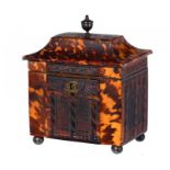 A REGENCY PRESSED TORTOISESHELL TEA CADDY, C1820 of pagoda form, the sides with arched windows,