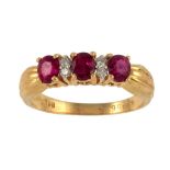 A RUBY AND DIAMOND RING in gold, with fluted shoulders, marked 750, inventory number, 4g, size N ++