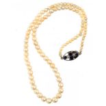 A CULTURED PEARL NECKLACE, C1930 of 98 cultured pearls ranging from 0.3-0.59cm, sapphire and diamond