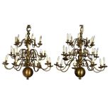 A PAIR OF BRASS 27 LIGHT CHANDELIERS, MID 20TH C with globe and multi-knopped shaft beneath