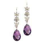 A PAIR OF DIAMOND AND AMETHYST EARRINGS with millegrain set diamond flower and leaves above a