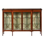 AN EDWARD VII MAHOGANY AND LINE INLAID BREAKFRONT CABINET, C1905 the top with turned brass gallery