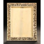 A CHINESE IVORY FRAME, CANTON, MID 19TH C typically carved with continuous scenes, ivory back and
