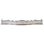 A PIERCED, ENGRAVED AND BURNISHED STEEL SERPENTINE FENDER, LATE 19TH/EARLY 20TH C decorated with