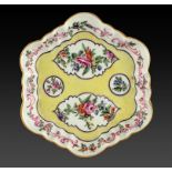 A WORCESTER TEAPOT STAND, THE PORCELAIN C1770 later enamelled with flowers on a yellow ground,