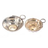 TWO FRENCH SILVER WINE TASTERS the larger embossed with grapevines, bowl 7 or 8cm diam, post-1838