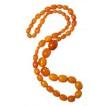 A NECKLACE OF 55 AMBER BEADS 115.1g