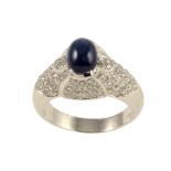 A SAPPHIRE AND DIAMOND RING the larger central sapphire en cabochon and pavé set diamond