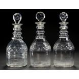 A SET OF THREE ENGLISH CUT GLASS DECANTERS AND STOPPERS, C1840 with three neck rings and target