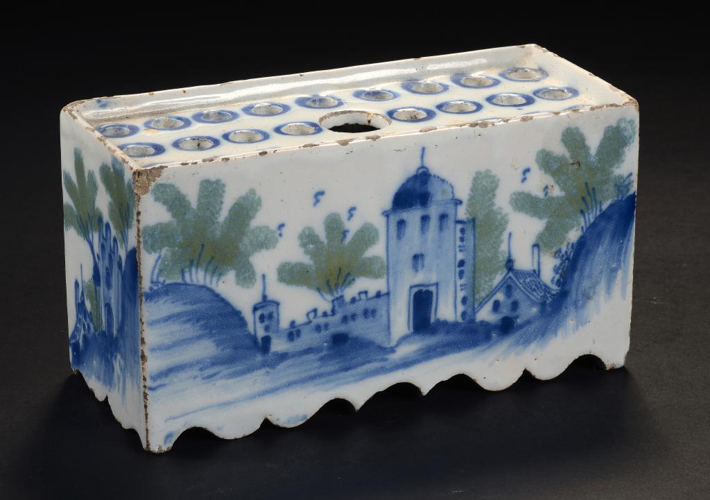 A DELFTWARE FLOWER BRICK, ENGLISH OR DUTCH, C1750 painted in cobalt and green to all four sides,