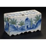 A DELFTWARE FLOWER BRICK, ENGLISH OR DUTCH, C1750 painted in cobalt and green to all four sides,