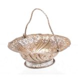 A GEORGE III PIERCED SILVER SWEETMEAT BASKET with spiral handle, chased with flowers, on pierced