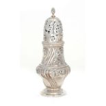 A VICTORIAN SILVER CASTER chased with flowers between wrythen fluting, 16cm h, maker's mark