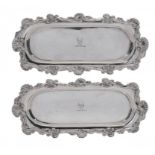 A PAIR OF GEORGE IV SILVER SNUFFER TRAYS of substantial gauge, the leafy scrolling rim with