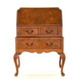 A FIGURED WALNUT BUREAU, 69CM W