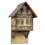 A LATE 19TH CENTURY WALL MOUNTED CANDLE BOX IN THE FORM OF A SWISS CHALET, WITH CARVED AND PAINTED