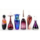 FIVE VARIOUS STUDIO GLASS BOTTLES AND STOPPERS AND A LOETZ STYLE BLUE IRIDESCENT GLASS VASE, 20CM H,