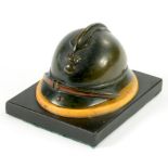 A FRENCH BRONZE SIENNA MARBLE AND POLISHED SLATE DESK WEIGHT IN THE FORM OF FIREMAN'S HELMET, 6CM H,