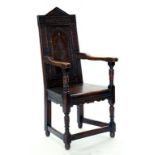 A CARVED OAK PANEL-BACK ARMCHAIR IN 17TH CENTURY ENGLISH STYLE, 119CM H