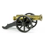 A BRASS MODEL CANNON ON IRON CARRIAGE, 33CM L OVERALL