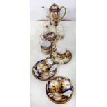 A NORITAKI COBALT GROUND COFFEE SERVICE PAINTED WITH LANDSCAPE PANELS IN RAISED GILT FRAMES,
