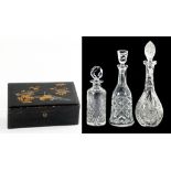 A JAPANESE LACQUER BOX, 30CM W, C1900 AND THREE CUT GLASS DECANTERS AND STOPPERS