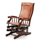 A 19TH CENTURY MAHOGANY STAINED AMERICAN ROCKING CHAIR