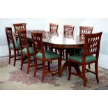 A MAHOGANY TWIN PILLAR DINING TABLE, 266CM L, WITH TWO LEAVES AND A SET OF EIGHT MAHOGANY DINING