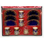 A SET OF SIX AYNSLEY BONE CHINA COBALT GROUND GILT COFFEE CUPS AND SAUCERS WITH PIECED SILVER CUP
