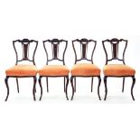 A SET OF FOUR EDWARDIAN CARVED MAHOGANY DINING CHAIRS