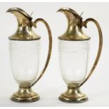 A PAIR OF AUSTRO HUNGARIAN SILVER MOUNTED GLASS CLARET JUGS OF SHIELD SHAPE, LOOPED HANDLE AND