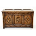 A CARVED OAK BLANKET BOX WITH PANELLED LID IN 18TH CENTURY STYLE, 108CM W