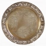 A VICTORIAN SILVER SALVER, THE PIECED BORDER EMBOSSED WITH MASKS AND HOUNDS, ON THREE PAW FEET, 27CM