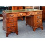 A MAHOGANY PEDESTAL DESK WITH GREEN LEATHER TOP, 137CM W