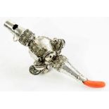 A GEORGE III SILVER BABY'S RATTLE embossed with florets and engraved in compartments, hung with