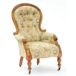 A VICTORIAN WALNUT ARMCHAIR