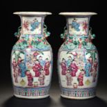 A PAIR OF CHINESE PORCELAIN CANTON FAMILLE ROSE VASES, 19TH C enamelled to either side with two