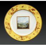 A DERBY PLATE, C1797-1800 painted probably by John Brewer with a landscape, the yellow border