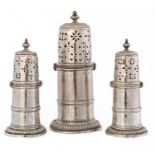 A WILLIAM III SILVER CASTER AND A PAIR OF QUEEN ANNE SILVER CASTERS fully marked, both London, the