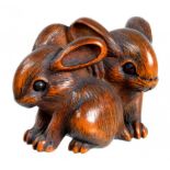 A JAPANESE BOXWOOD NETSUKE OF LEVERETS, EDO PERIOD, 19TH C unsigned, 4cm l ++In fine condition and