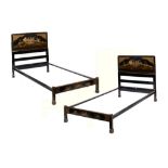 A PAIR OF BLACK JAPANNED SINGLE BEDS, C1930 decorated with scenes and diaper reserves, 106cm w ++